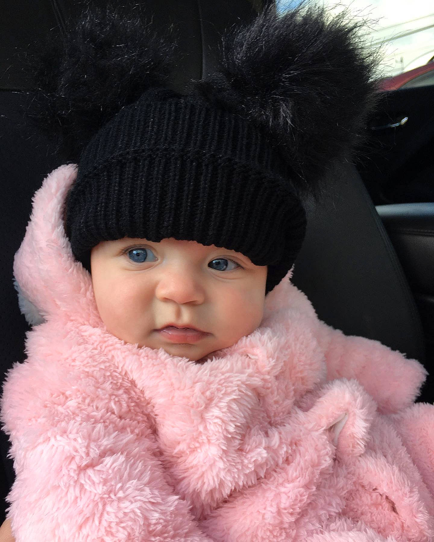 Alexandra joined the competition — help win amazing prizes! animal_product, black_hair, cap, cool, eyebrow, eyelash, fur, fur_clothing, hairstyle, head, headgear, headwear, knit_cap, lip, outerwear, person, pink, sleeve, textile, toddler