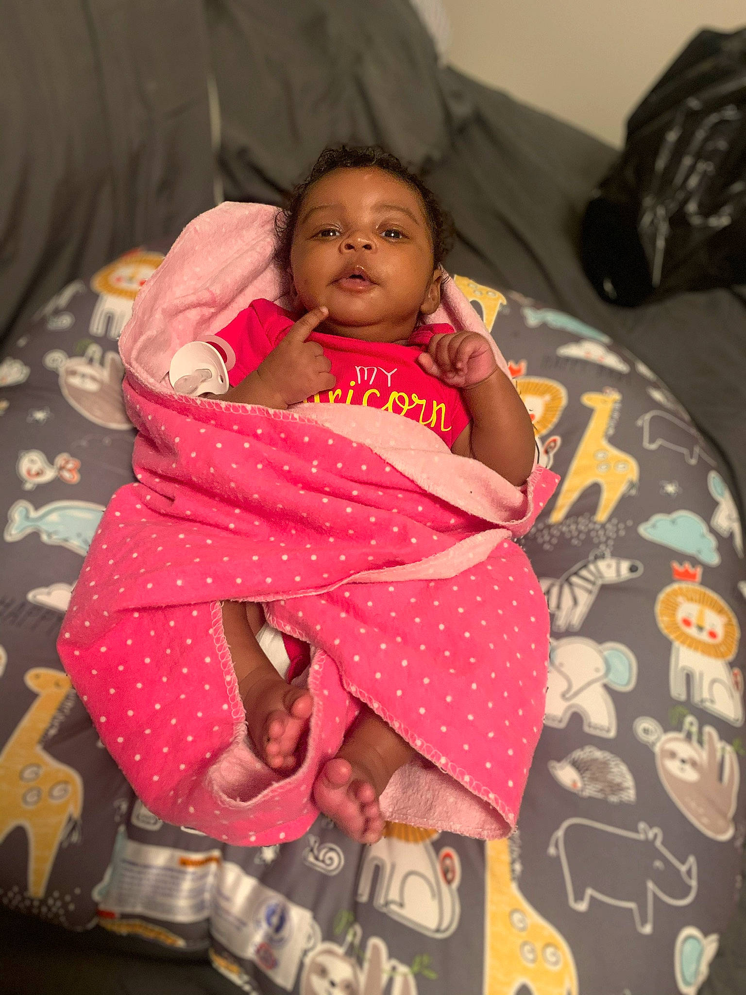Dariyah is registered to the contest to win money with this photo: abdomen, arm, baby, baby_products, bedding, bedtime, cheek, child, comfort, event, happy, human_body, linens, magenta, mammal, mouth, person, pink, room, skin
