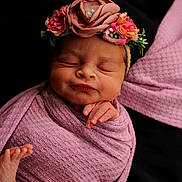 Saylah is registered to the contest to win money with this photo: newborn, baby, sleeping, wrapped, blanket, pink, flower_crown, headband, peaceful, infant, skin, hand, foot, portrait, cute, soft_texture, closeup, resting, adorable, baby_bracelet