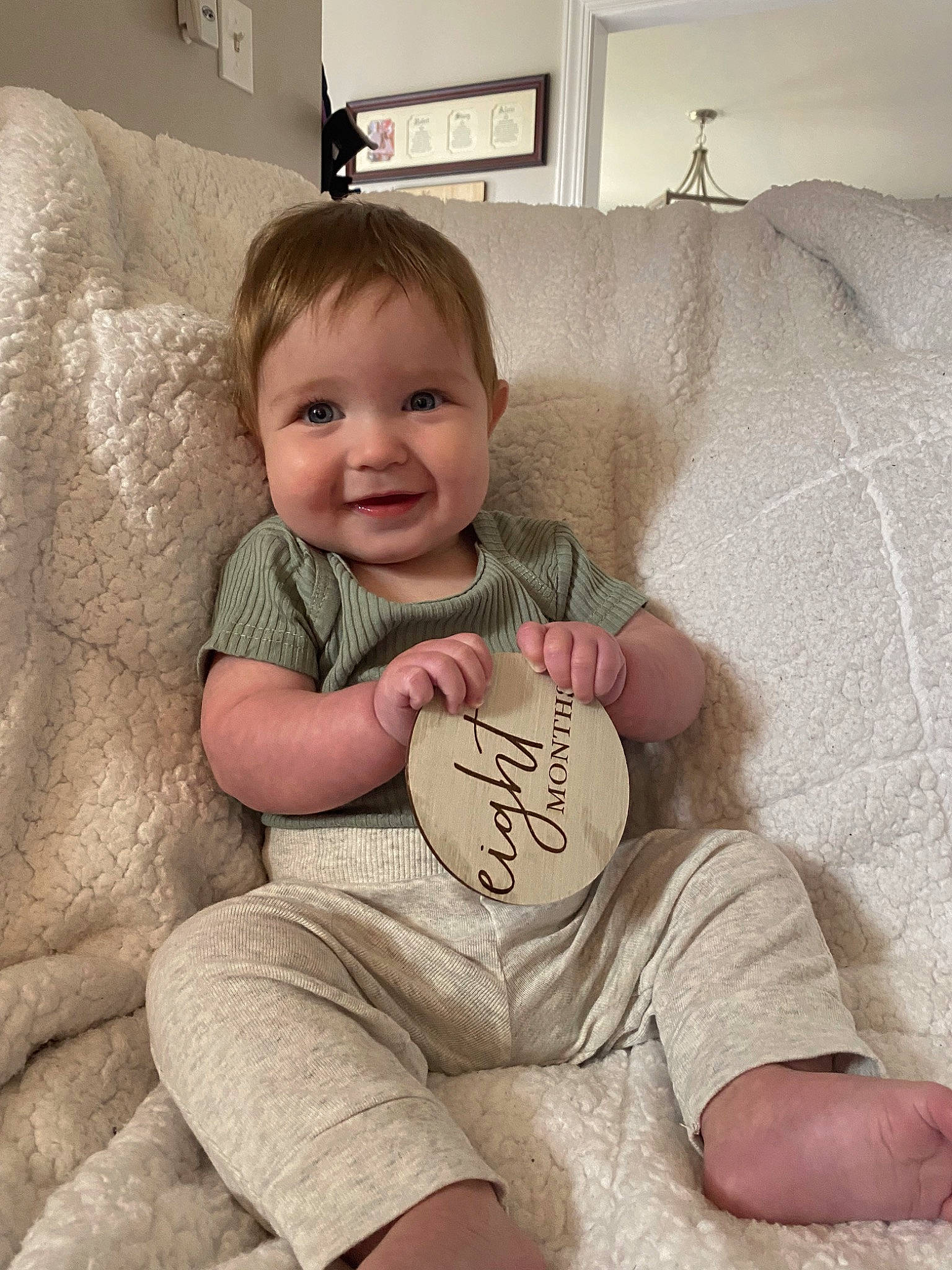 Drew is registered to the contest to win money with this photo: baby, baby_toddler_clothing, child, comfort, couch, eye, face, flooring, hair, happy, head, human_leg, joy, knee, lamp, person, skin, sleeve, smile, t_shirt