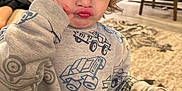 Owen is registered to the contest to win money with this photo: blowing, carpet, celebration, child, cute, expression, floor, funny_face, furniture, hand, holiday, home, indoor, living_room, party_hat, person, pout, sweatshirt, toy, young_child