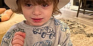 Owen joined the competition — help win amazing prizes! child, party_hat, celebration, indoor, young_child, toy, noisemaker, sweatshirt, patterned_clothing, car_print, smiling, person, home, carpet, furniture, adult_in_background, party, holiday, festive, floor