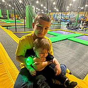 Brandon joined the competition — help win amazing prizes! child, children, trampoline_park, indoor, yellow_shirt, black_clothes, green_light, wristband, playing, fun, joy, family, activity, sports, recreation, happy, smiling, casual, jeans, footwear