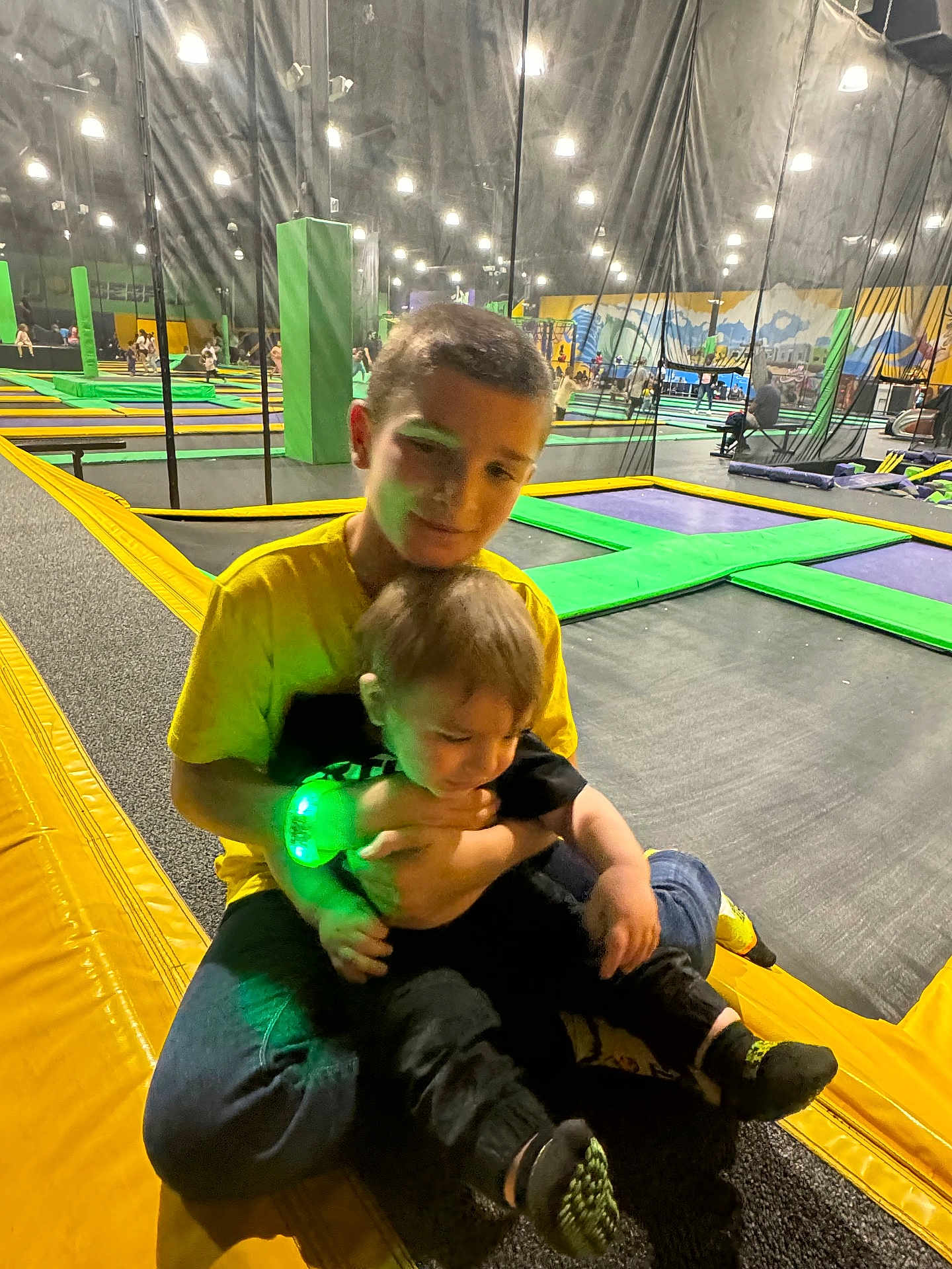 Brandon joined the competition — help win amazing prizes! child, children, trampoline_park, indoor, yellow_shirt, black_clothes, green_light, wristband, playing, fun, joy, family, activity, sports, recreation, happy, smiling, casual, jeans, footwear