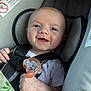 Julian joined the competition — help win amazing prizes! baby, infant, smile, car_seat, pacifier, harness, safety_strap, onesie, hand, cheek, head, seat, fabric, warning_sticker, closeup, portrait, happy, cute, parenting, accessory