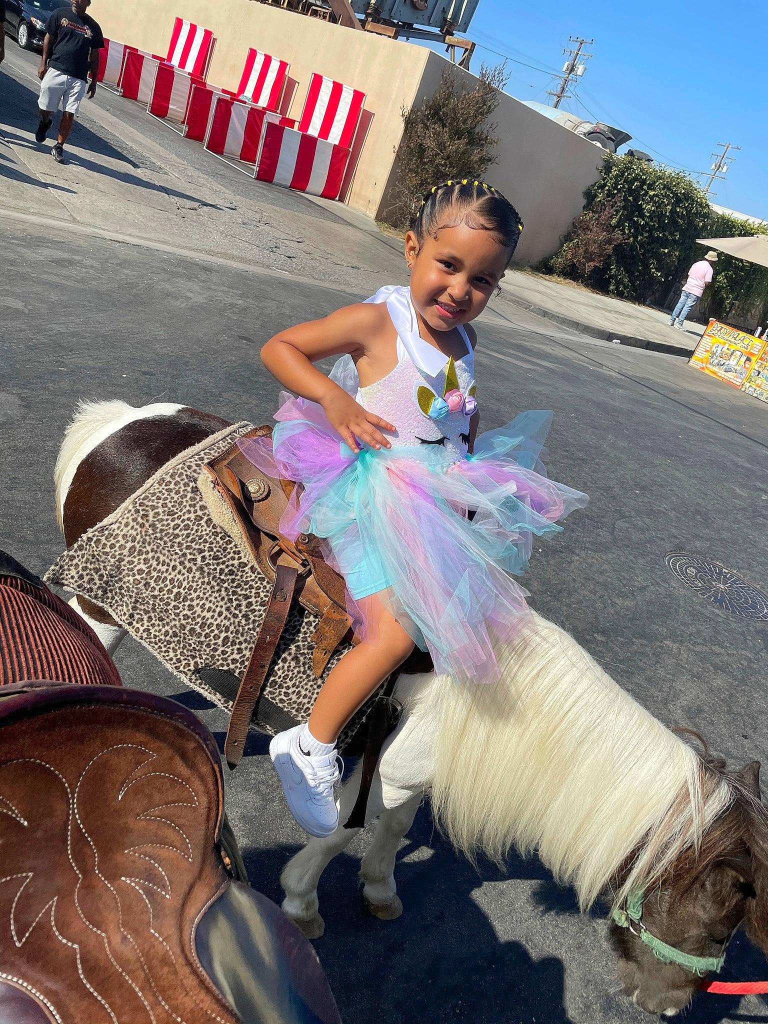 Jaylani joined the competition — help win amazing prizes! asphalt, child, event, fashion_design, festival, fun, happy, human_leg, joy, leisure, magenta, pedestrian, person, pink, public_event, recreation, road, sandal, shoe, sky