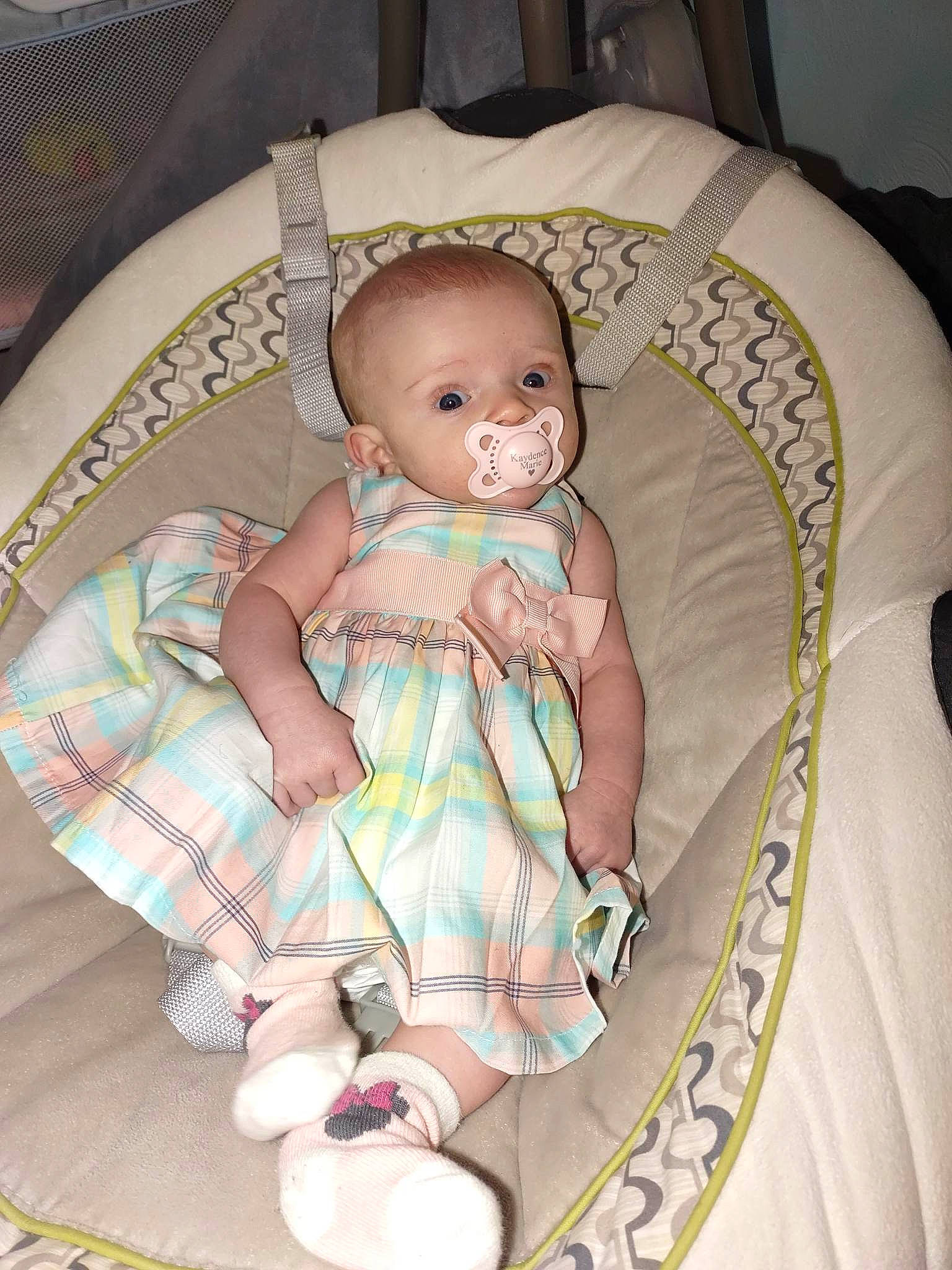 Kaydence is registered to the contest to win money with this photo: baby, baby_carriage, baby_products, baby_toddler_clothing, chair, cheek, child, comfort, eye, finger, head, infant_bed, leg, linens, pattern, person, product, sitting, skin, textile