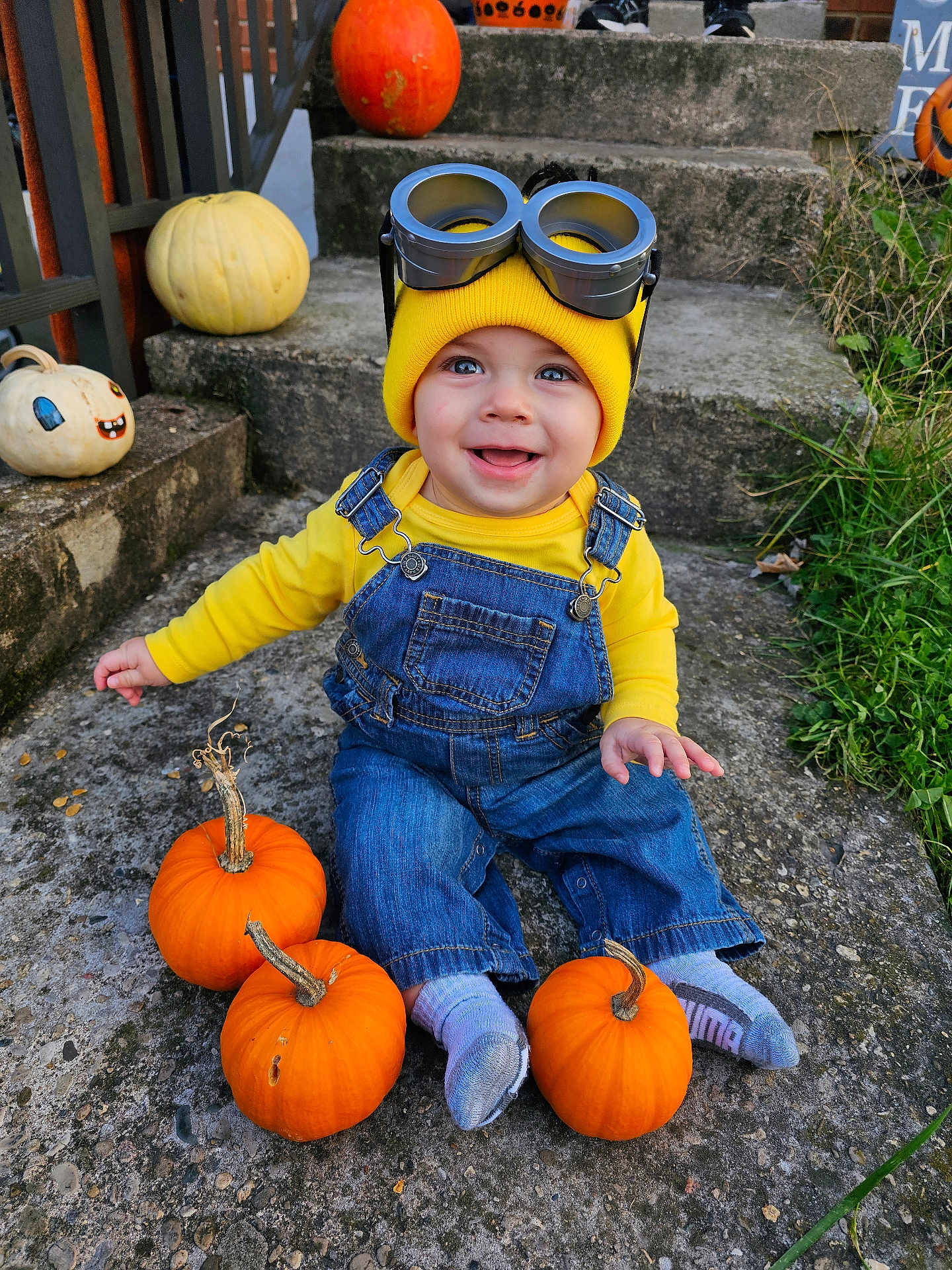 Robert joined the competition — help win amazing prizes! baby, child, concrete, costume, cute, denim, fall, goggles, grass, halloween, happy, minion, outdoor, overalls, pumpkin, seasonal, smiling, steps, toddler, yellow_hat