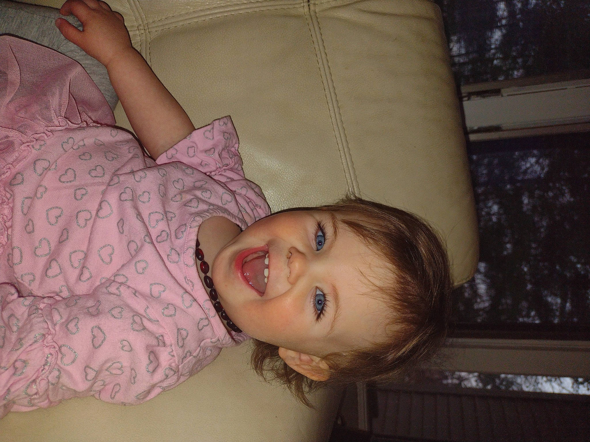 Delaney joined the competition — help win amazing prizes! baby, blond, cheek, child, comfort, couch, eyelash, fun, happy, lip, mouth, neck, nose, pattern, person, room, sitting, skin, smile, toddler