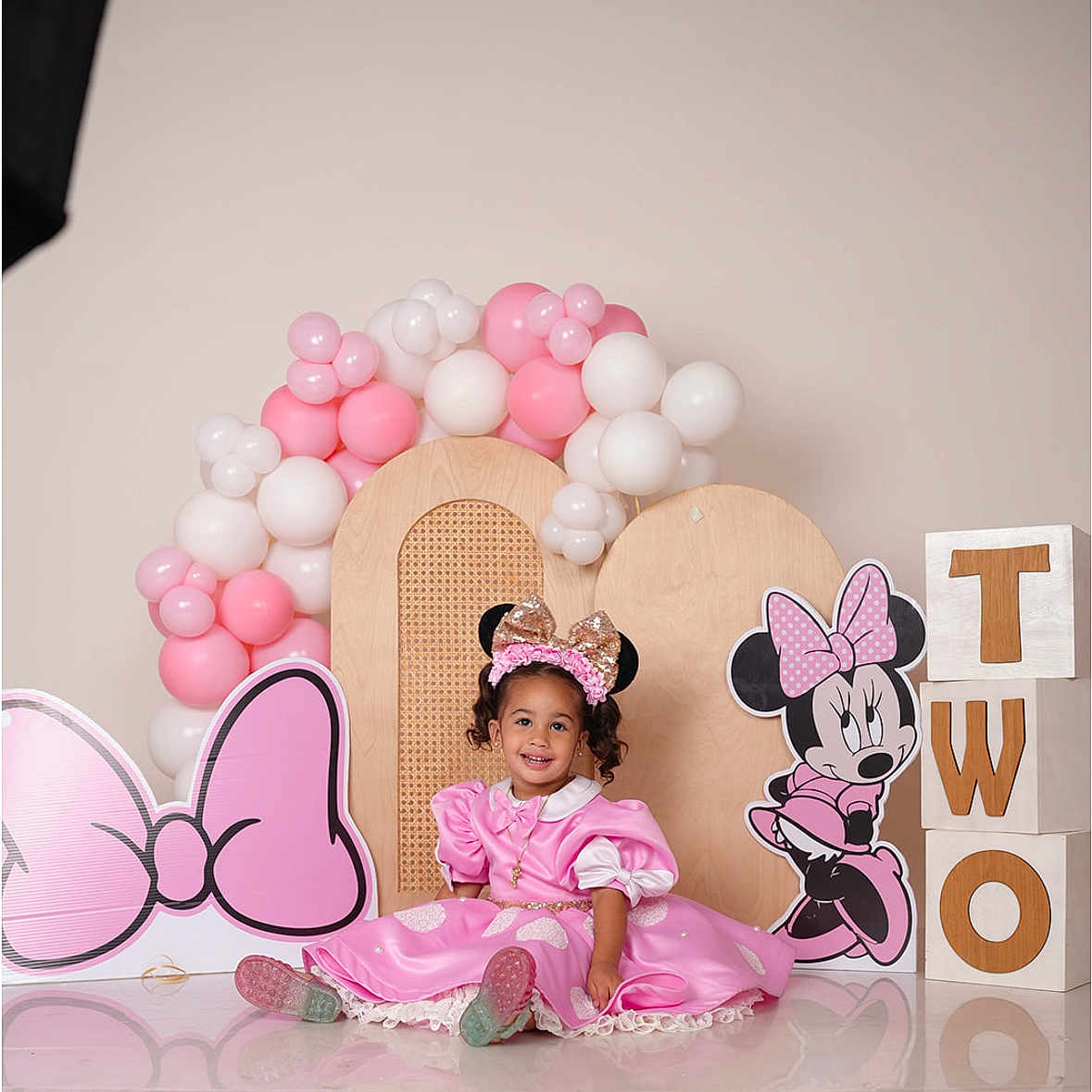 Silvia is registered to the contest to win money with this photo: balloons, birthday, blocks, cartoon, celebration, child, costume, cute, decorations, floor, happy, headband, indoor, minnie_mouse, party, pink_dress, portrait, sitting, smile, toddler