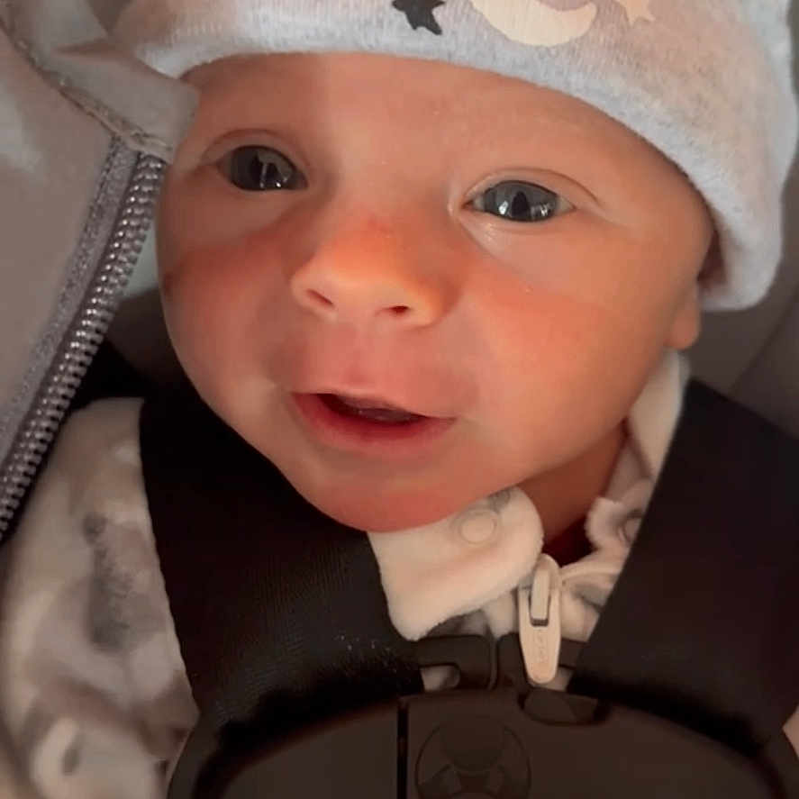 Joshua is registered to the contest to win money with this photo: accessories, baby, beanie, belt, bodypart, bonnet, cap, clothing, face, finger, hand, happy, hat, head, hood, newborn, person, photography, portrait, smile