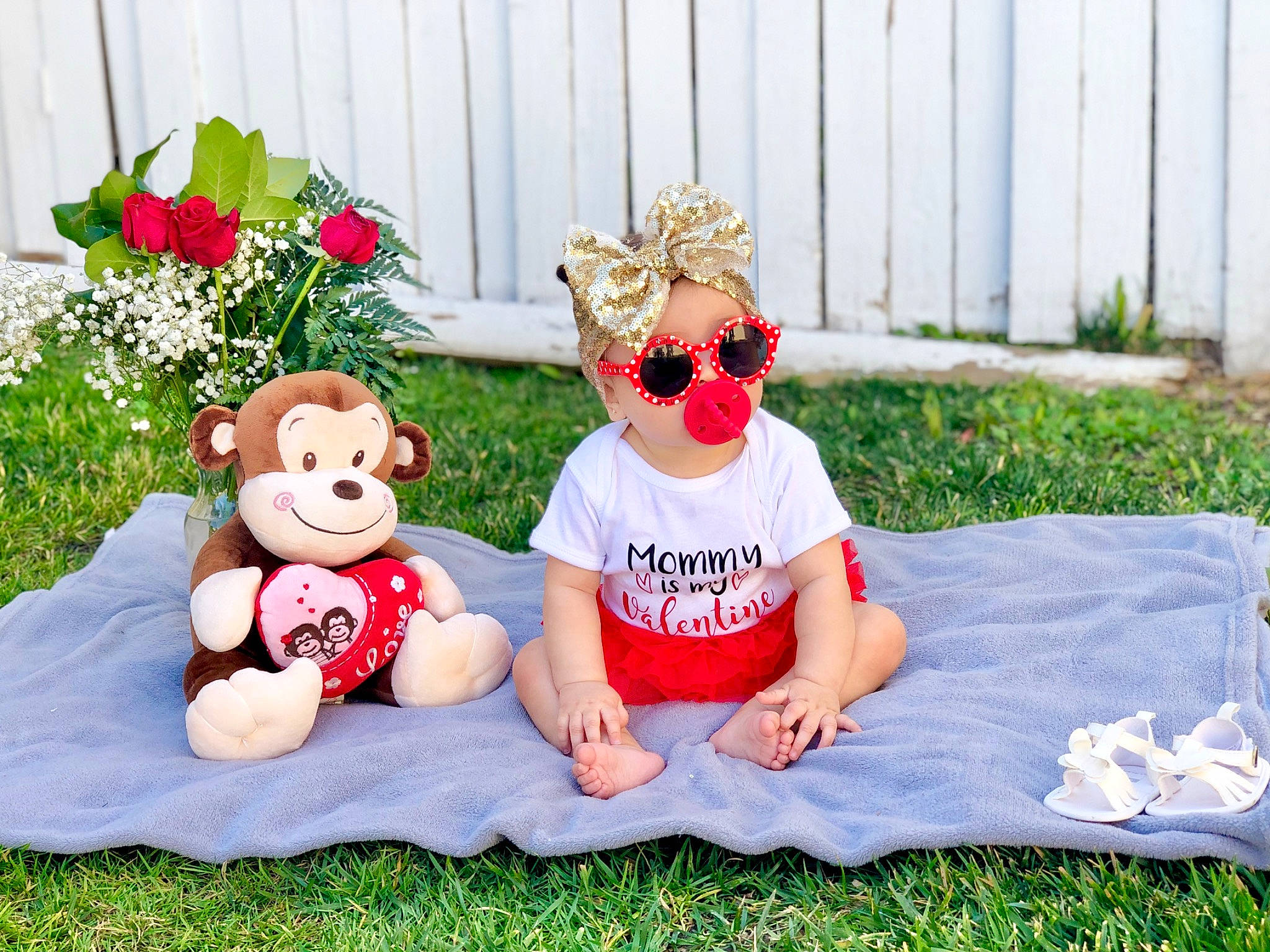 Remy is registered to the contest to win money with this photo: baby, child, flower, garden, grass, happy, headgear, lawn, person, photography, plant, plush, recreation, red, stuffed_toy, summer, textile, toddler, toy, vacation