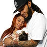 baby, infant, adults, family, parents, portrait, cuddling, sleeping, smiling, affection, indoor, white_background, baseball_cap, beard, dreadlocks, long_hair, tattoos, floral_blanket, white_shirt, family_photo