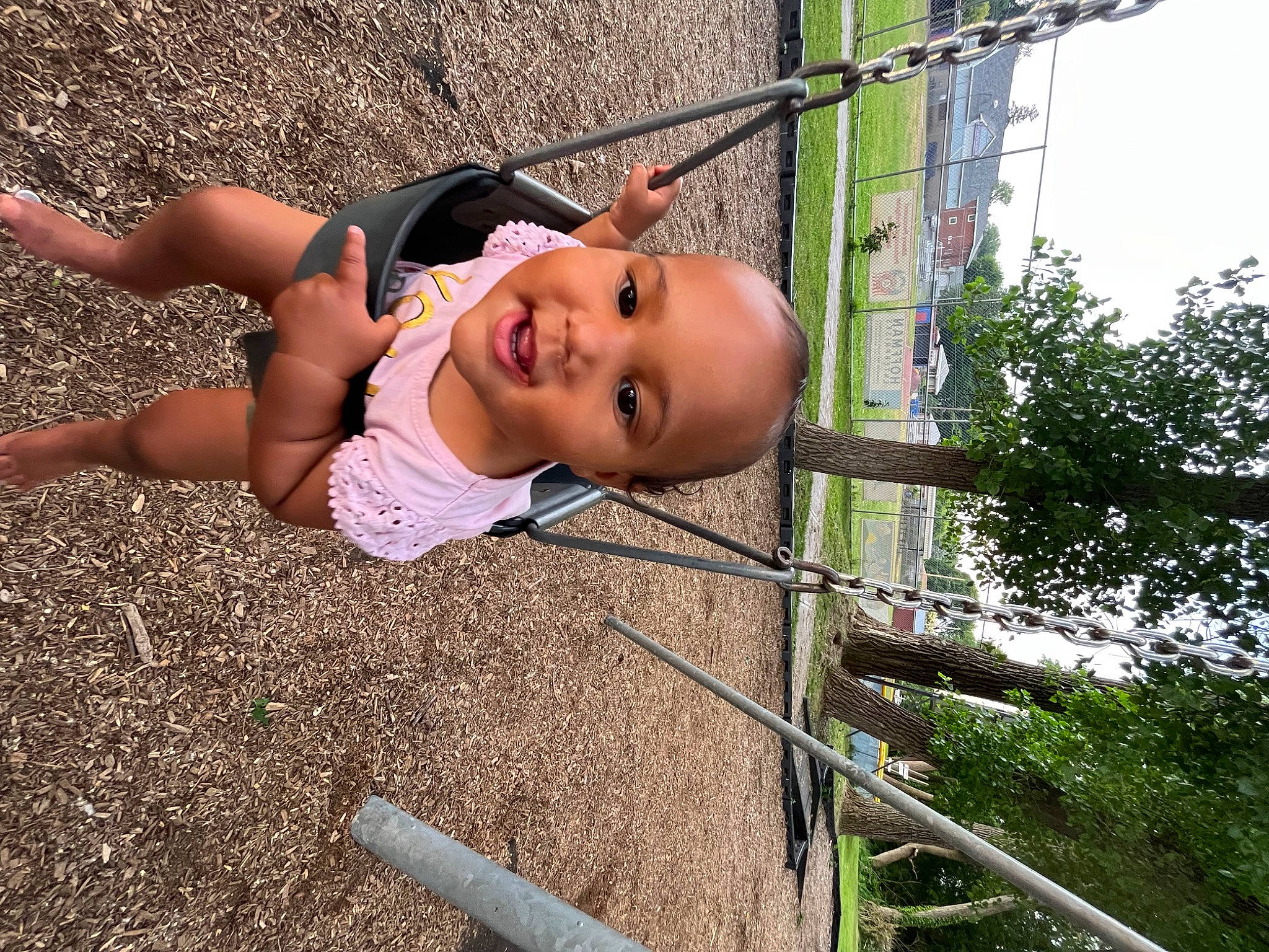 Londyn joined the competition — help win amazing prizes! baby, child, city, eyewear, fun, grass, happy, hat, landscape, leisure, outdoor_play_equipment, people_in_nature, person, plant, recreation, smile, soil, swing, thigh, toddler