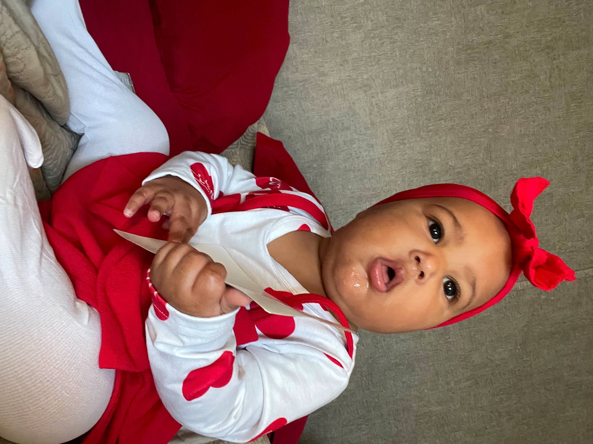 Londyn is registered to the contest to win money with this photo: baby, baby_toddler_clothing, carmine, christmas, comfort, costume, costume_hat, fictional_character, finger, fun, happy, hat, headgear, human_body, human_leg, knee, person, santa_claus, sleeve, surprise