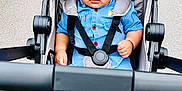 Jack joined the competition — help win amazing prizes! baby, child, stroller, blue_outfit, seatbelt, barefoot, outdoor, pavement, curious, young_child, cute, infant, walking_path, black_hair, sitting, safety_harness, summer_clothing, daylight, portrait, person