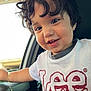 toddler, child, curly_hair, smiling, white_tshirt, logo, lee_brand, car_interior, window, door_handle, bracelet, happy, portrait, young_child, close_up, casual_clothing, cute, person, indoor, daylight