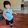 Jesús joined the competition — help win amazing prizes! child, toddler, indoor, floor, wood_floor, blue_shirt, shorts, black_shoes, person, hair, face, walking, home, adult_arm, window, tile_floor, bracelet, puma_logo, casual_clothing, light