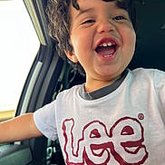 Jesús joined the competition — help win amazing prizes! child, smiling, happy, curly_hair, tshirt, lee_logo, car_interior, window, seat, person, portrait, casual_clothing, young_child, joyful, laughing, daylight, human_face, mouth_open, teeth, arm