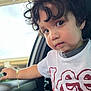 Jesús joined the competition — help win amazing prizes! toddler, child, curly_hair, white_shirt, red_graphic, car_interior, car_door, bracelet, hand, window, looking_away, portrait, indoors, daylight, casual_clothing, young_child, face, expression, person, cute