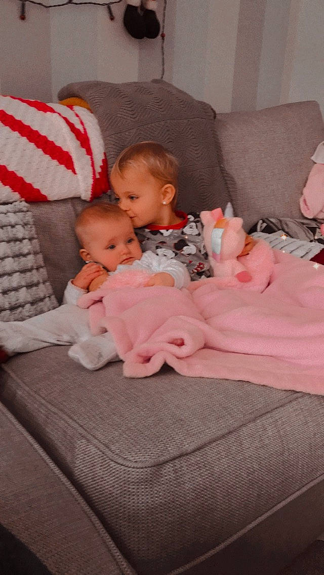 Jr is registered to the contest to win money with this photo: baby, baby_sleeping, baby_toddler_clothing, bedding, bedtime, child, comfort, couch, lap, linens, living_room, nap, person, pillow, pink, sitting, skin, sock, t_shirt, throw_pillow