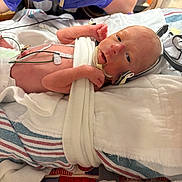 Walker joined the competition — help win amazing prizes! newborn, baby, infant, hospital, medical_equipment, blanket, gloved_hand, cross, bed, sensor, care, healthcare, patient, tubes, monitoring, tiny, premature, lying_down, person, closeup