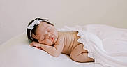 Wrenley joined the competition — help win amazing prizes! newborn, baby, sleeping, infant, portrait, indoor, bed, blanket, white_bow, headband, curled_up, peaceful, soft_lighting, closeup, face, skin, resting, nursery, bedroom, photography