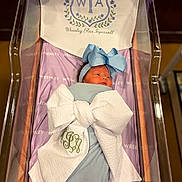 Wrenley is registered to the contest to win money with this photo: baby, bassinet, blanket, blue, bow, crib, embroidery, floral, headband, indoors, infant, newborn, nursery, peaceful, portrait, purple, ribbon, sleeping, swaddled, textile