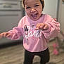 Lilly-Rae joined the competition — help win amazing prizes! child, toddler, smiling, laughing, headband, pink_sweatshirt, barbie_logo, teeth, kitchen, refrigerator, hardwood_floor, motion_blur, candid, indoor, portrait, playful, reaching_hand, black_leggings, happy, person