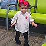 Lilly-Rae joined the competition — help win amazing prizes! child, toddler, girl, red_headband, big_bow, curly_hair, white_sweater, heart_patch, black_leggings, black_boots, waiting_room, green_chairs, patterned_chair, wood_floor, standing, surprised_expression, indoor, young_child, portrait, playful