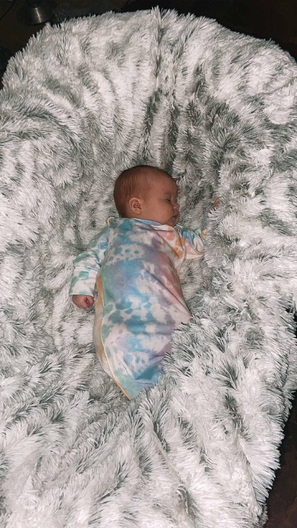 Oaklee joined the competition — help win amazing prizes! baby, baby_toddler_clothing, bedtime, comfort, face, flooring, fur, fur_clothing, grass, linens, outerwear, pattern, person, room, sitting, skin, sleeve, t_shirt, textile, toddler