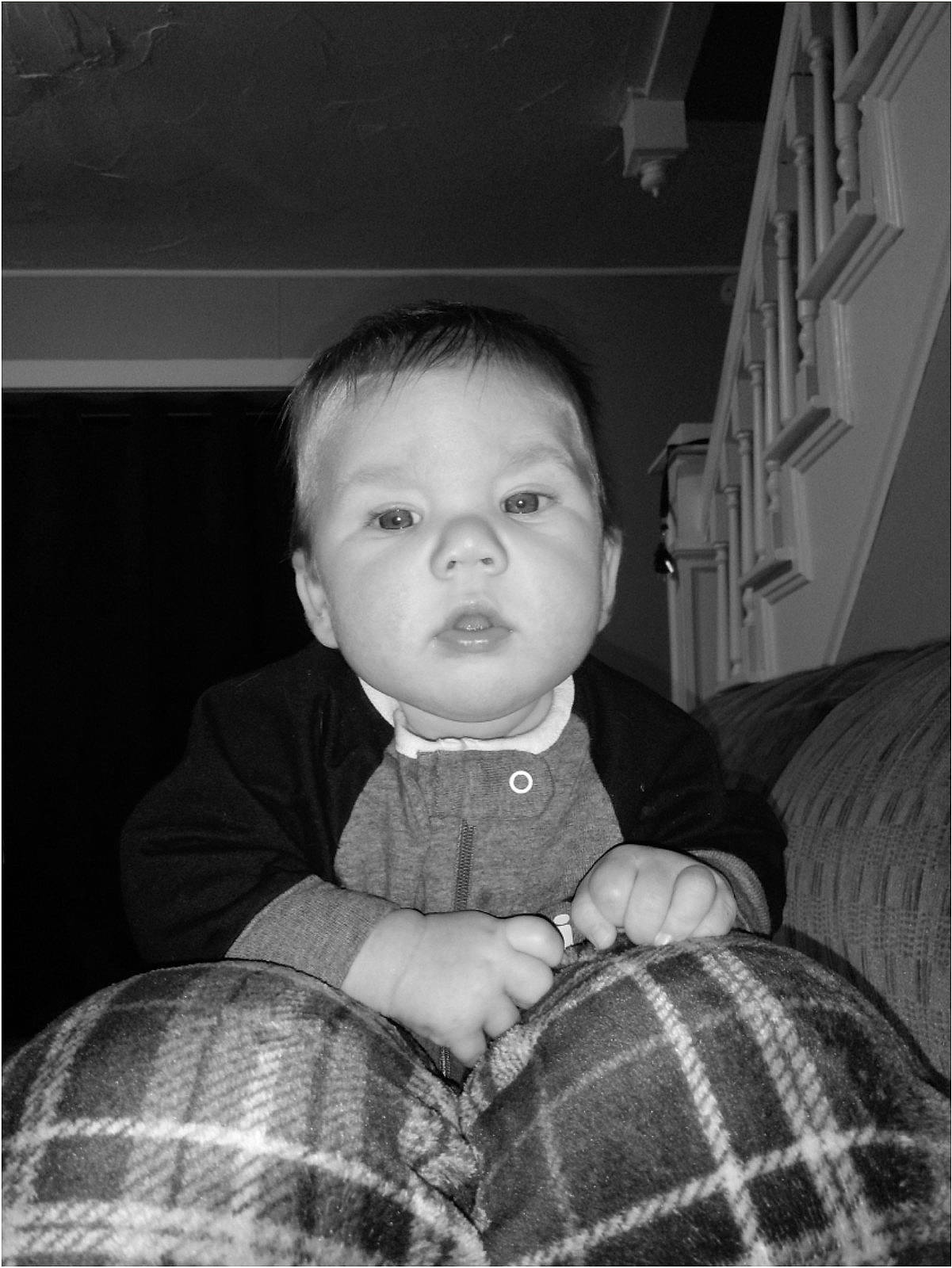 Erik joined the competition — help win amazing prizes! baby, baby_toddler_clothing, cheek, comfort, couch, ear, home, iris, knitting, linens, living_room, person, plaid, shelf, sitting, sweater, tartan, textile, toddler, wool