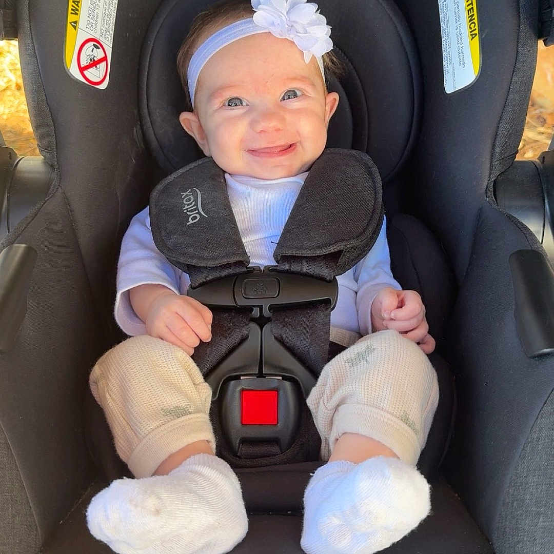 Vivian joined the competition — help win amazing prizes! baby, car_seat, britax, child, smiling, headband, white_flower, socks, clothing, infant, seatbelt, black, safety, cute, happy, outdoor, person, portrait, toddler, baby_girl