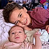 Vivian is registered to the contest to win money with this photo: baby, child, siblings, smile, curly_hair, blanket, indoors, family, cute, portrait, toddler, clothing, happy, face, couch, home, infant, cuddling, person, laying_down