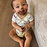 Adriel is registered to the contest to win money with this photo: baby, child, infant, sitting, smiling, messy, chocolate, food, crumbs, face, hands, legs, onesie, couch, floor, indoor, home, portrait, cute, snack
