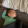 baby, sleeping, onesie, blanket, pillow, bed, quilt, face, child, indoor, rest, peaceful, cozy, soft, toddler, young_child, person, comfort, nap, quiet