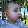 Adriel joined the competition — help win amazing prizes! baby, child, face, sunscreen, outdoor, daylight, green_fence, grass, tree, person, curious, striped_shirt, skin, head, ear, cheek, eyes, mouth, portrait, summer