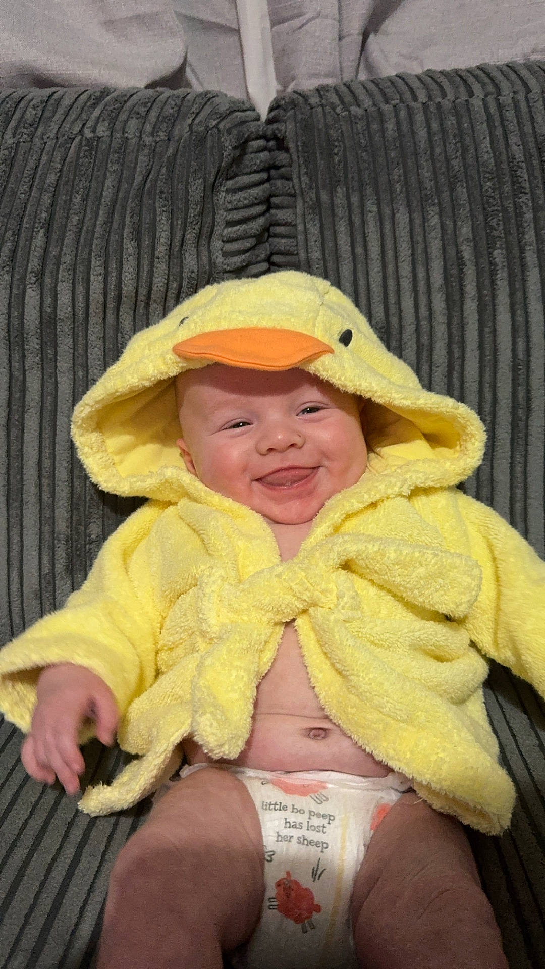 baby, blanket, bonnet, cap, clothing, coat, couch, diaper, face, furniture, hat, head, homedecor, hood, jacket, newborn, person, photography, portrait, towel