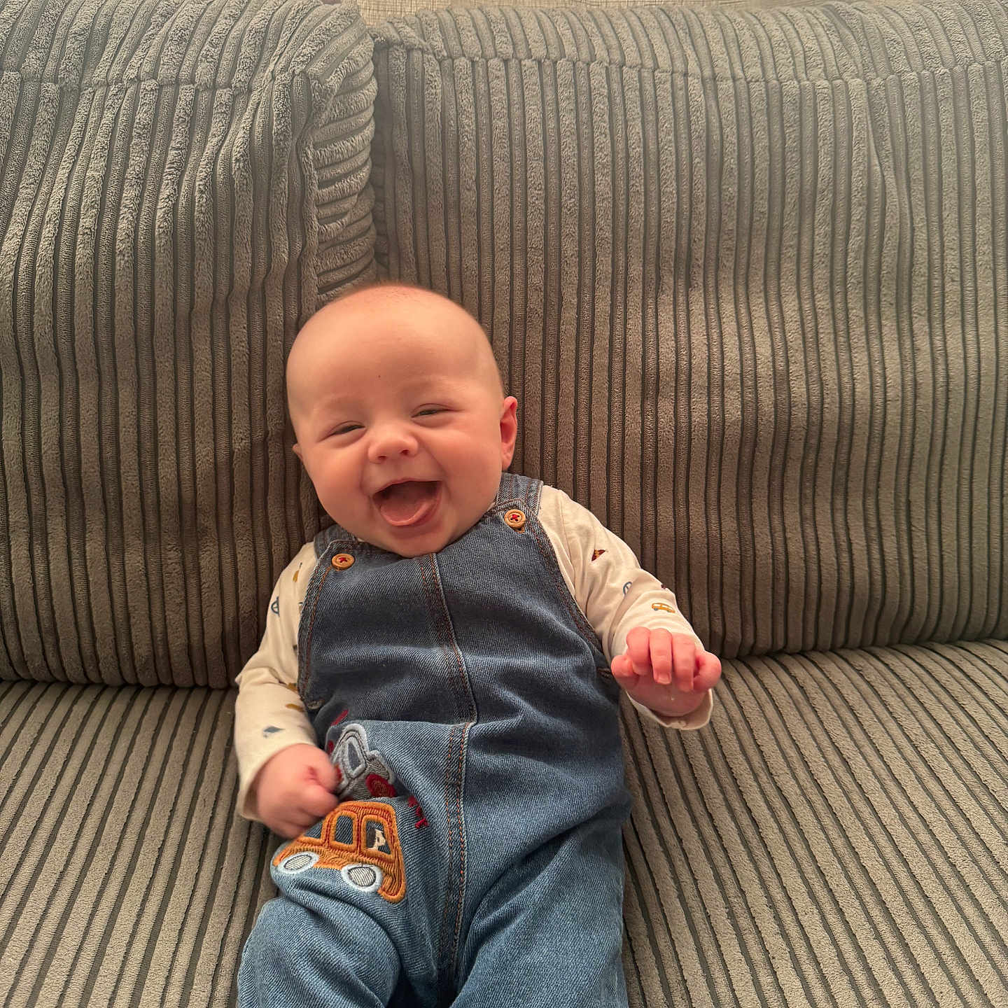 Lucca joined the competition — help win amazing prizes! architecture, baby, building, clothing, couch, cushion, face, furniture, happy, head, homedecor, indoors, jeans, laughing, pants, person, photography, portrait, sitting, smile