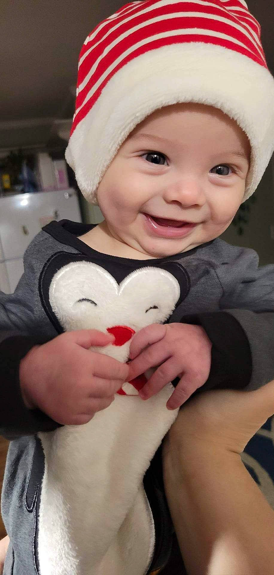 Braylin is registered to the contest to win money with this photo: arm, baby, baby_toddler_clothing, cap, cheek, eye, face, facial_expression, finger, hand, happy, head, headwear, human_body, joy, lip, mouth, organ, person, pink
