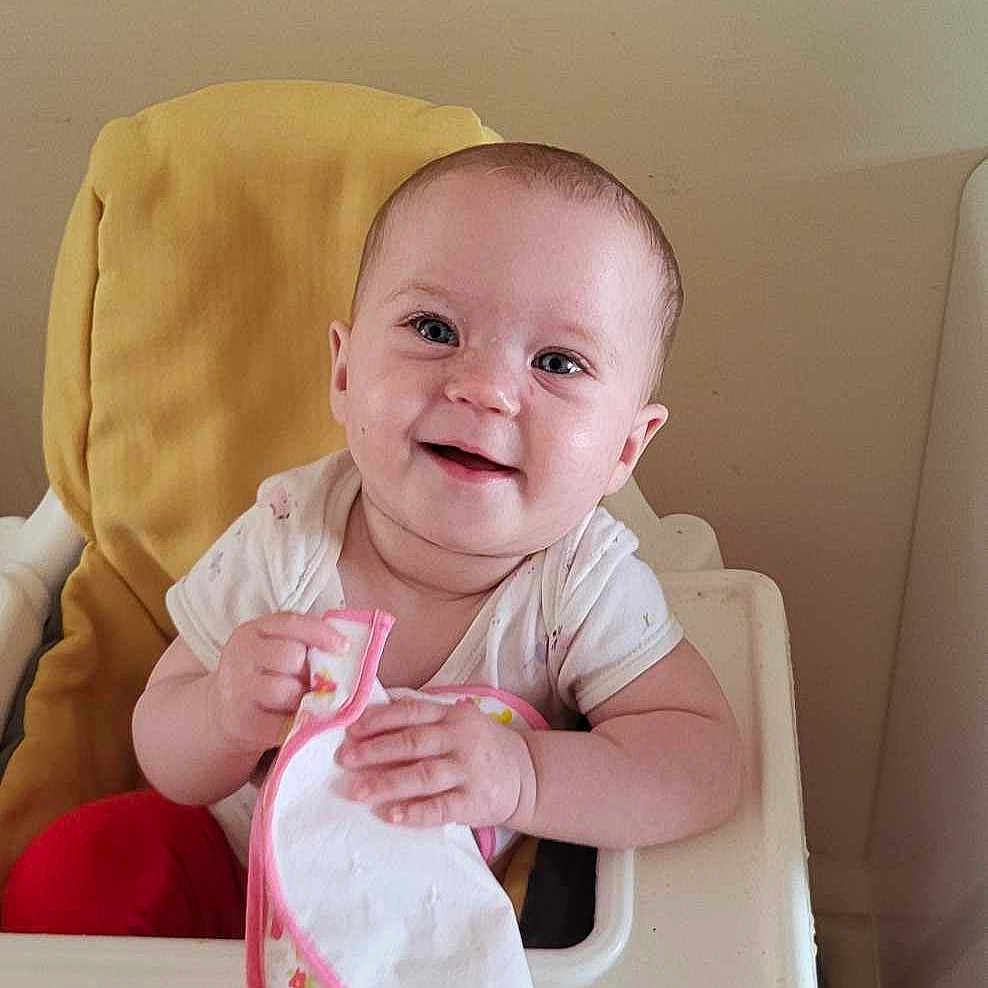 Isabella joined the competition — help win amazing prizes! baby, beverage, bib, chair, clothing, cushion, cutlery, face, furniture, head, homedecor, milk, person, photography, plant, portrait, pottedplant, sitting, spoon, t_shirt