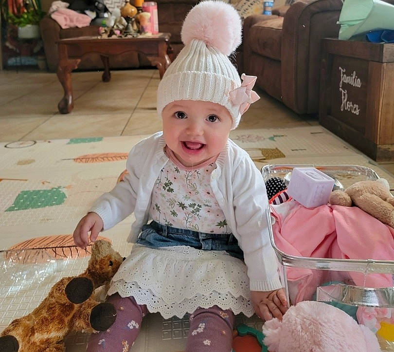 Scarlett joined the competition — help win amazing prizes! baby, baby_toddler_clothing, child, embellishment, event, fashion_accessory, flooring, fun, happy, hat, headwear, joy, magenta, pattern, person, pink, room, shipping_box, sitting, sleeve