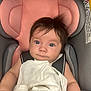 baby, car_seat, blanket, bracelet, child, infant, face, hair, person, seat_belt, pink, gray, white, clothing, indoors, cute, portrait, looking_at_camera, young_child, toddler