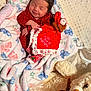Meara is registered to the contest to win money with this photo: newborn, baby, blanket, plush_toy, teddy_bear, red_clothing, sleeping, smiling, face, infant, cute, holiday, christmas, decor, soft_texture, cozy, indoors, child, resting, comfort