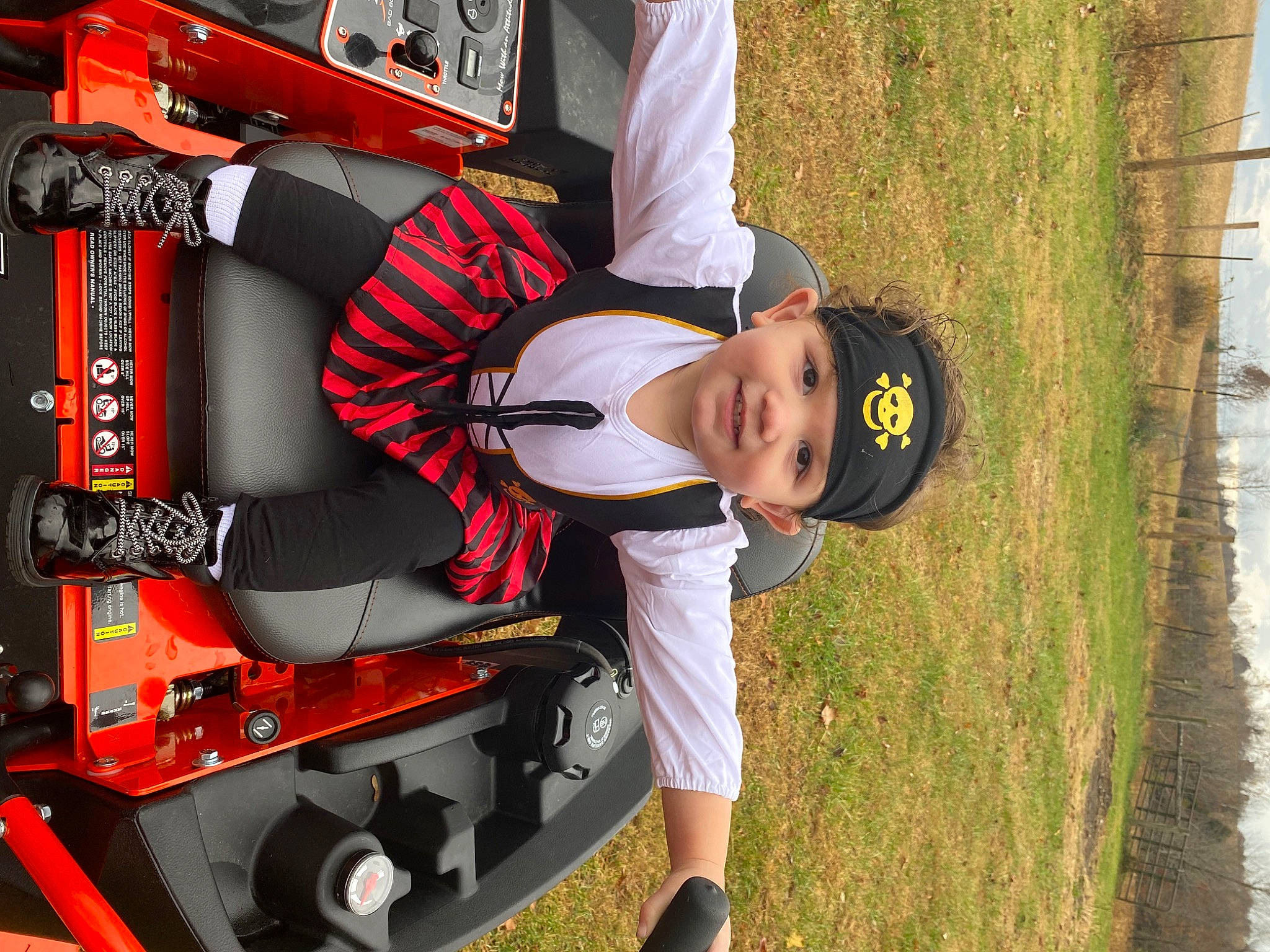 Ariya is registered to the contest to win money with this photo: auto_part, automotive_design, automotive_exterior, automotive_tire, automotive_wheel_system, bumper, carmine, fun, grass, hat, headwear, house, joy, machine, motor_vehicle, person, personal_protective_equipment, sports_gear, t_shirt, toddler