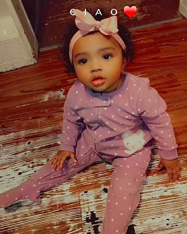 Alianna is registered to the contest to win money with this photo: arm, baby_toddler_clothing, cheek, ear, eyelash, facial_expression, fawn, fun, hairstyle, happy, head, headwear, magenta, organ, pattern, person, pink, skin, sleeve, toddler