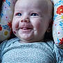 Willow joined the competition — help win amazing prizes! baby, child, smiling, blue_eyes, onesie, floral_pattern, cushion, face, cheeks, tongue, happy, infant, closeup, cute, skin, head, portrait, seated, indoors, soft_lighting