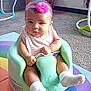 baby, infant, headband, pink_flower, baby_seat, mint_green, rainbow_mat, carpet, plush_toy, bear_toy, socks, striped_bib, indoor, child, cute, seated, floor, curious, soft_toys, colorful
