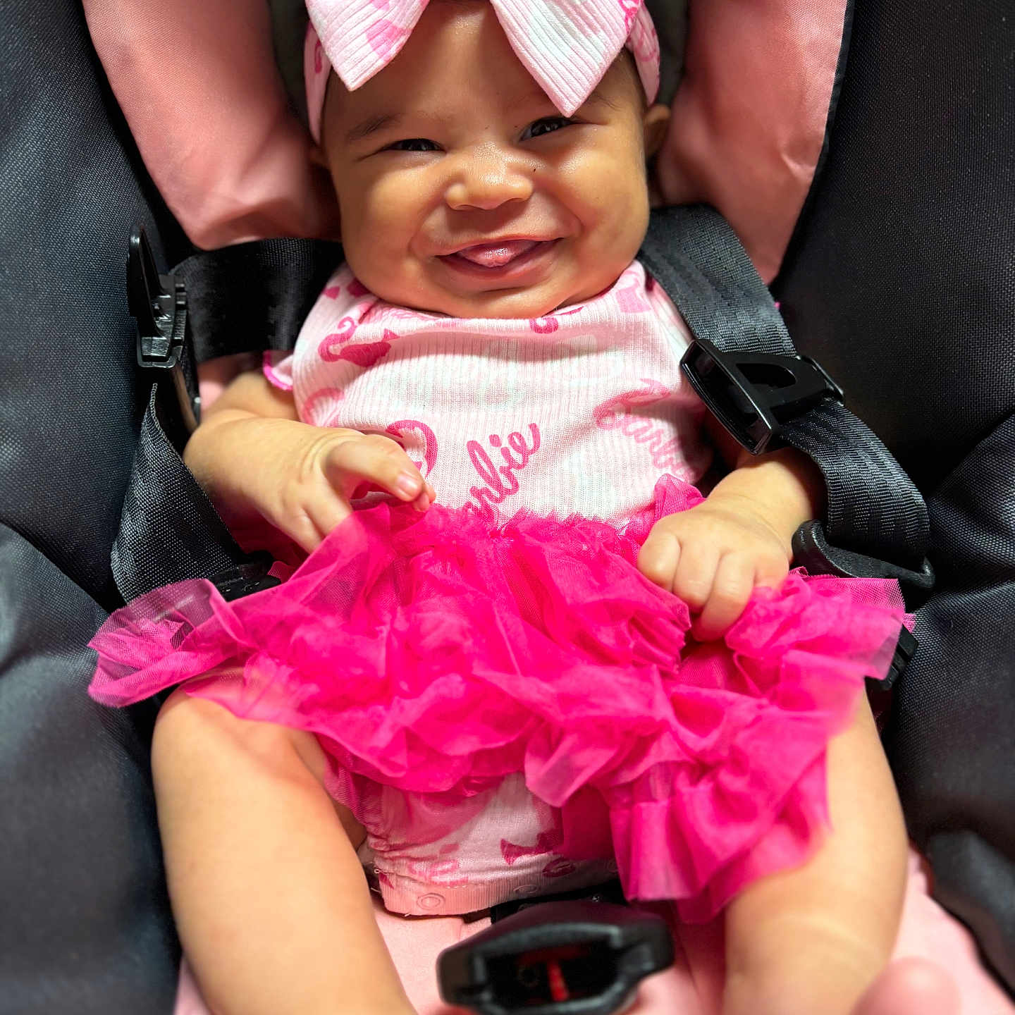 Azalea is registered to the contest to win money with this photo: baby, baby_girl, car_seat, child, closeup, clothing, cute, fabric, happy, headband, human, indoors, infant, pink_bow, pink_dress, portrait, seatbelt, sitting, skin, smiling