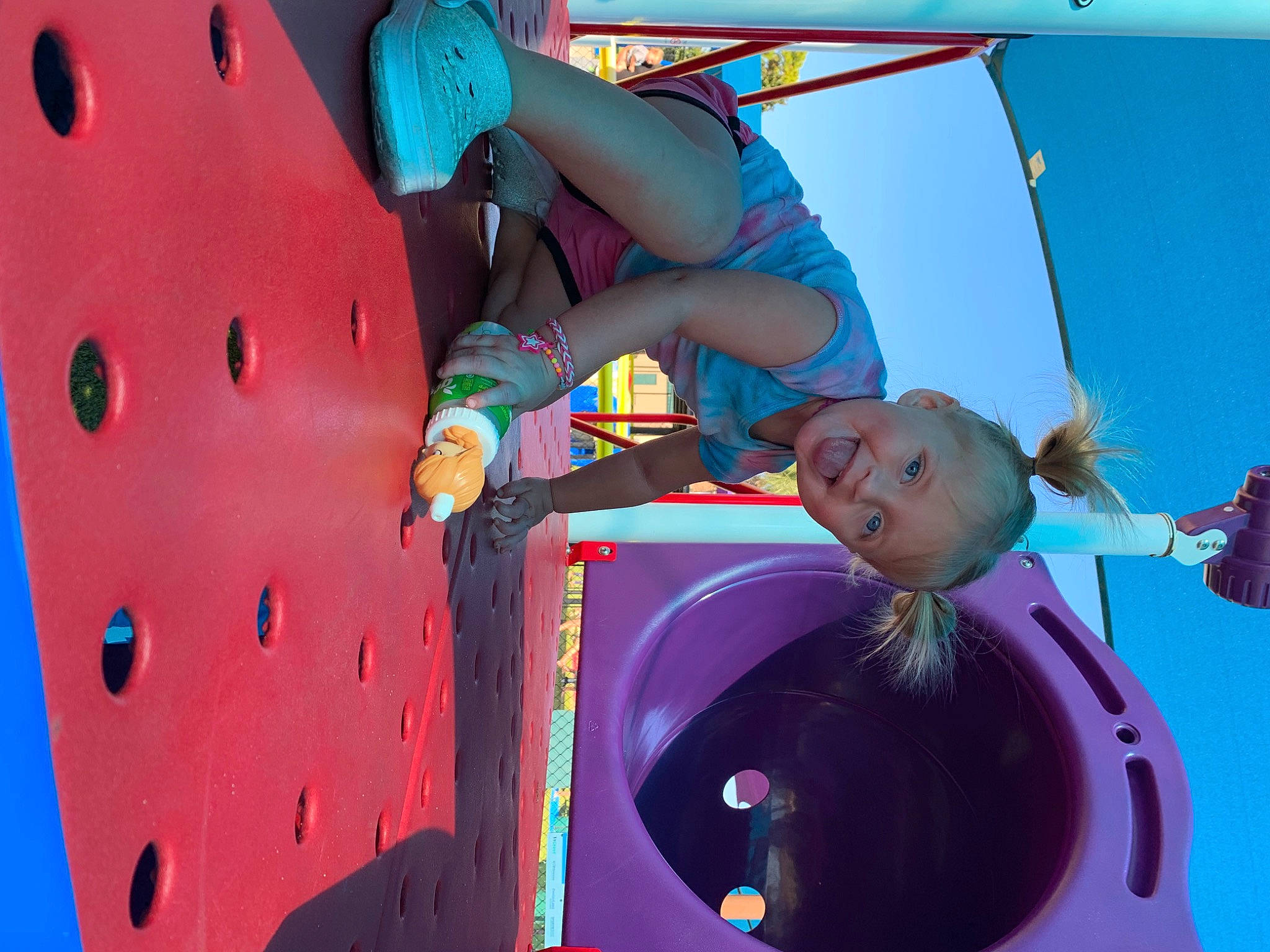 Indy is registered to the contest to win money with this photo: bouldering, child, climbing, climbing_hold, design, electric_blue, entertainment, event, fun, happy, leisure, magenta, outdoor_play_equipment, people, person, pink, playground, recreation, sport_climbing, toddler